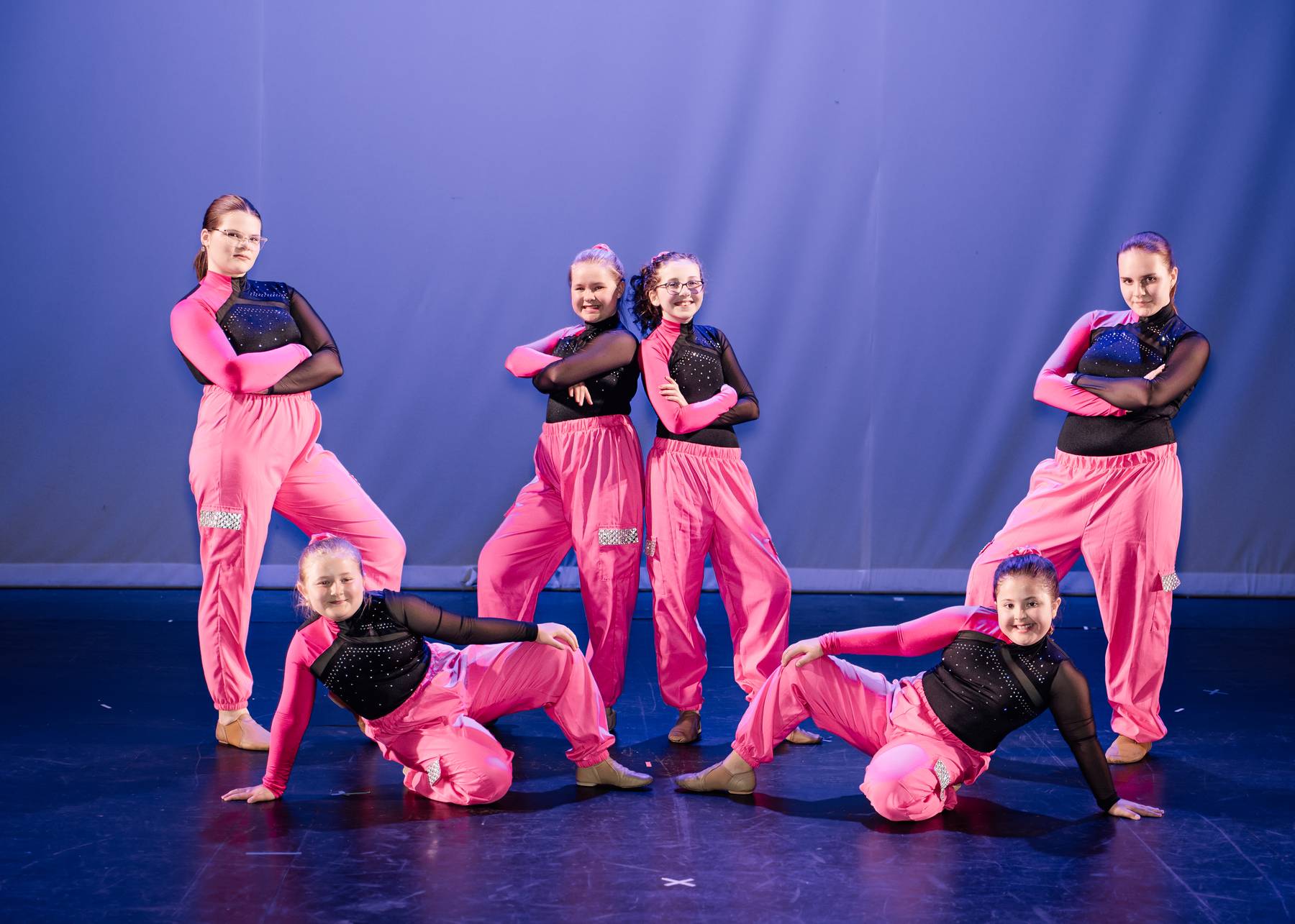 Jazz dancers posing together on stage